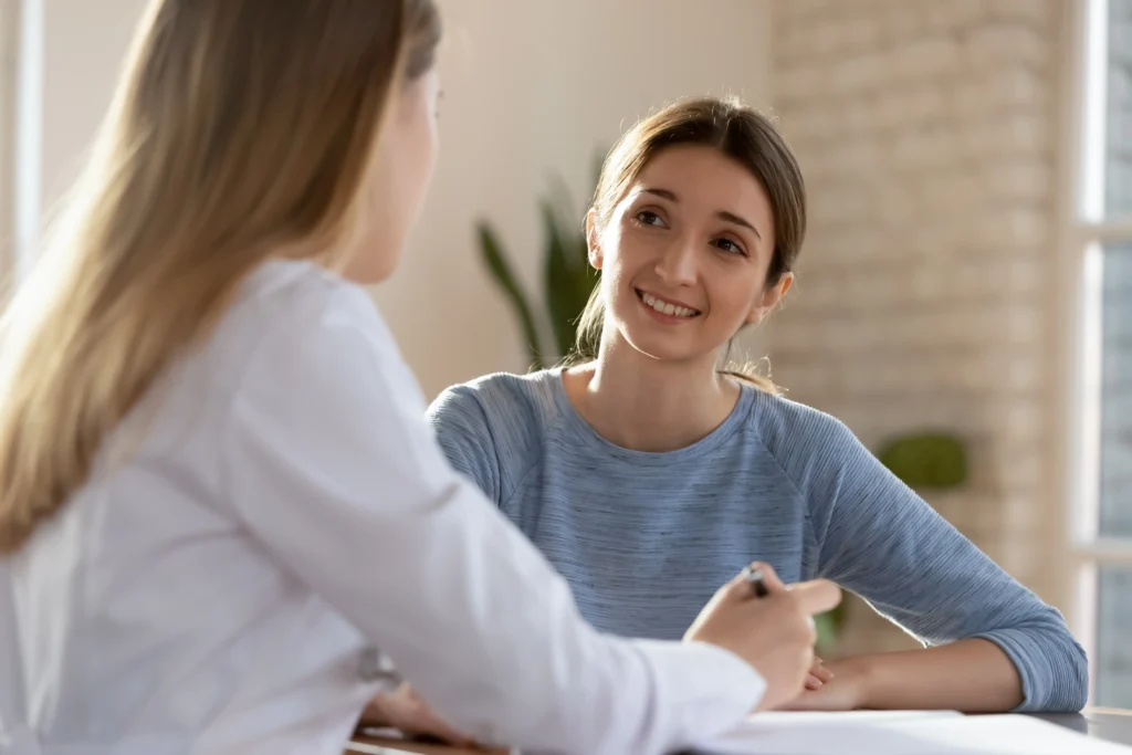 Female doctor consulting patient at hospital meeting